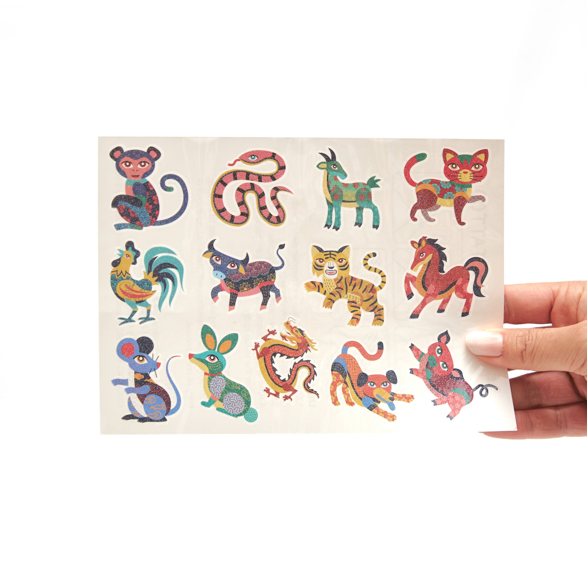 Set of glittery temporary tattoos showcasing all 12 Chinese Zodiac animals, plus Vietnamese variation, perfect for kids’ creative expression and cultural exploration.