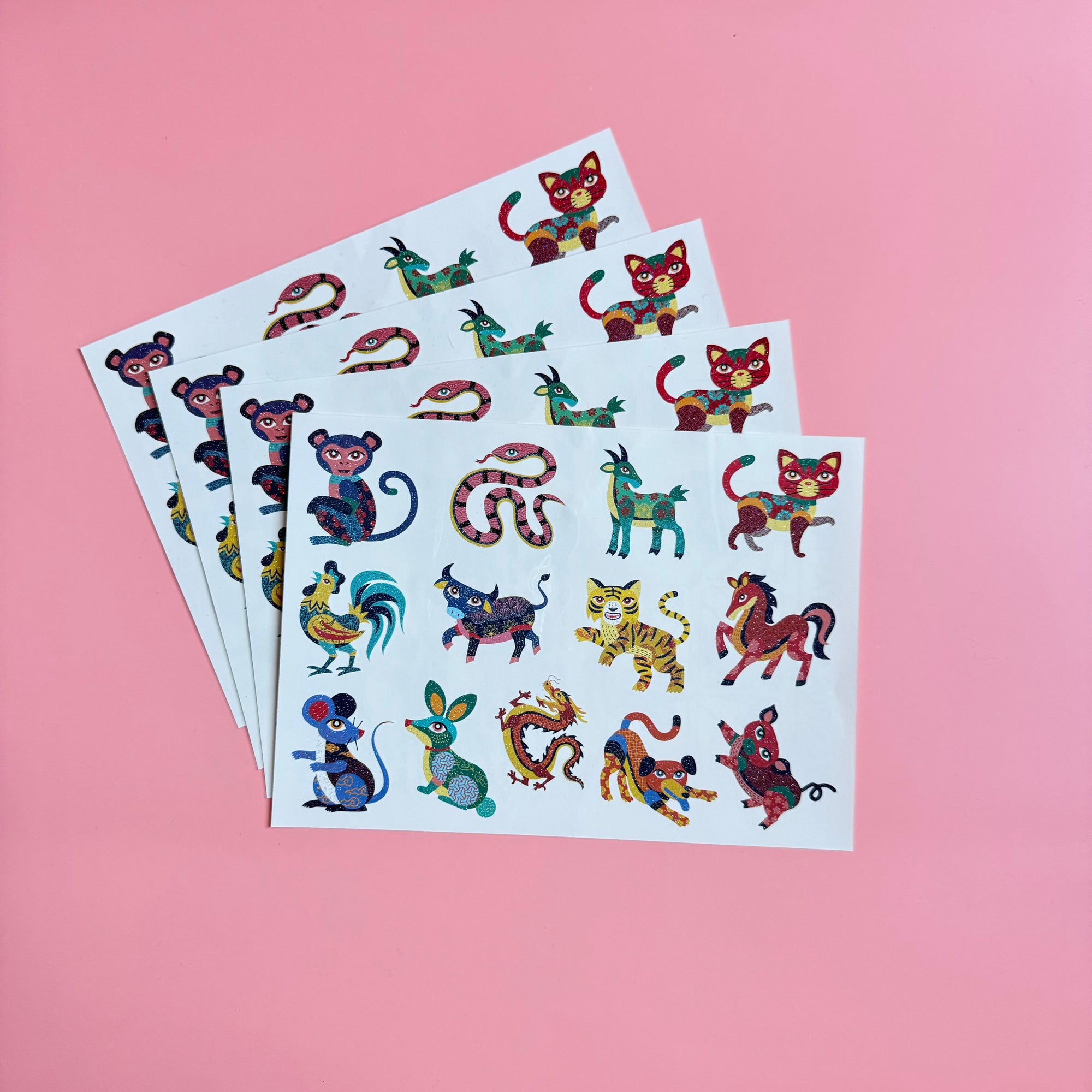 Set of glittery temporary tattoos showcasing all 12 Chinese Zodiac animals, plus Vietnamese variation, perfect for kids’ creative expression and cultural exploration.